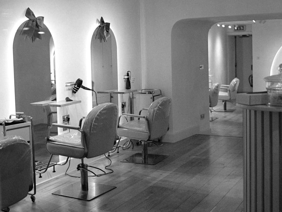 A bright modern salon interior with styling chairs and mirrors